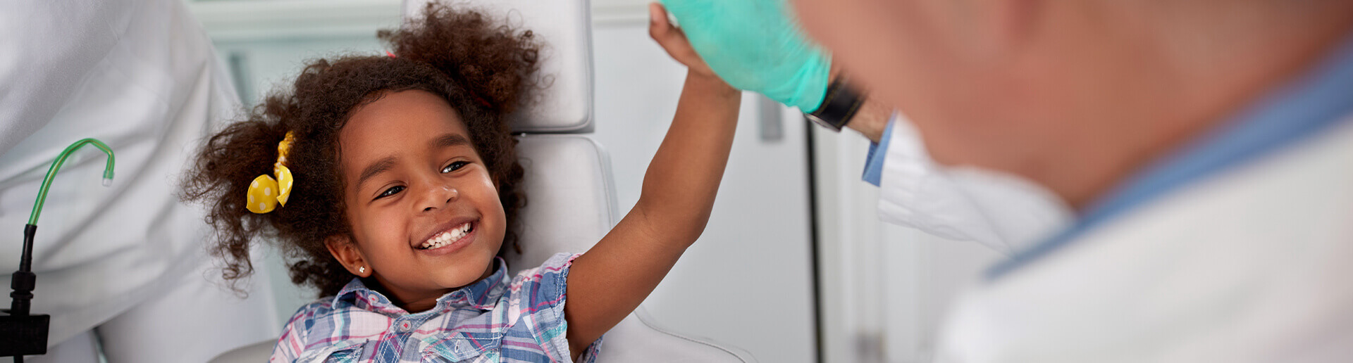 little girl giving her dentist a high five
