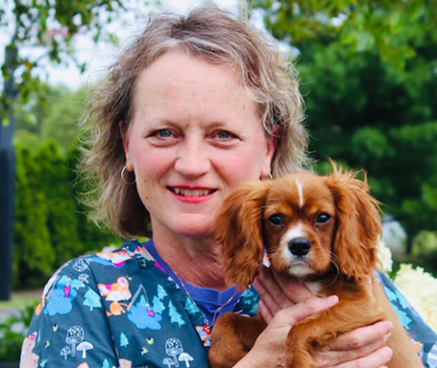 Dr. Gill holding a puppy