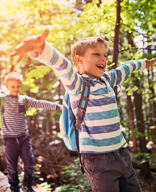 two young boys enjoying a hike in the woods