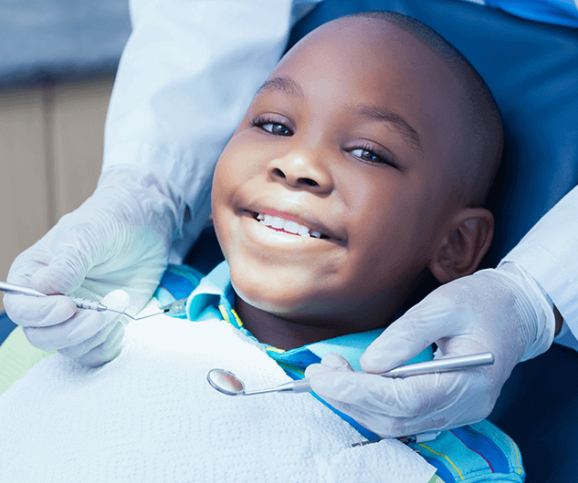 boy in dental chair smiling