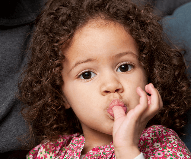 little girl sucking thumb