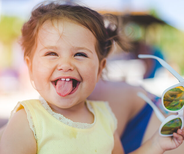 baby smiling and sticking out her tongue